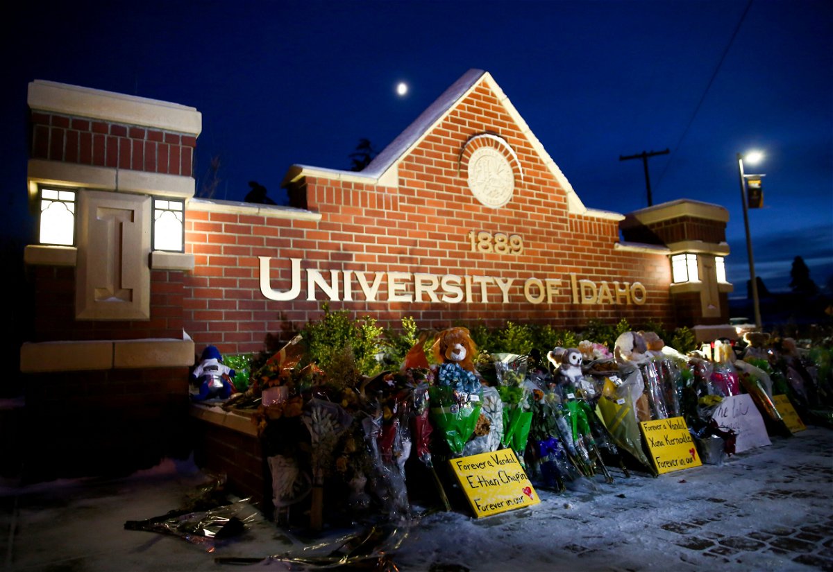 <i>Lindsey Wasson/Reuters</i><br/>A memorial for four students found dead in their residence is seen in front of a University of Idaho campus sign