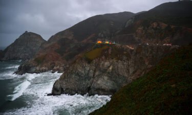 Rescue teams are pictured here at the Pacific Coast Highway location where a Tesla plunged over a cliff on January 2.