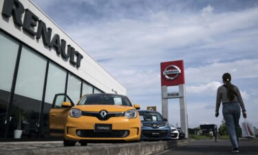 Renault will slash stake in Nissan as they overhaul their alliance. Pictured is a Nissan and Renault car dealership on May 27