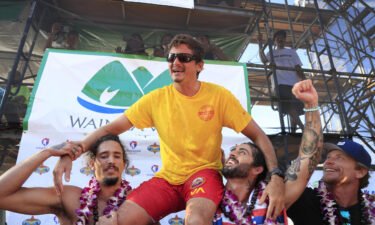 Luke Shepardson is congratulated by fellow surfers Landon McNamara (left) and Billy Kemper after winning the Eddie Aikau Big Wave Invitational at Waimea Bay.