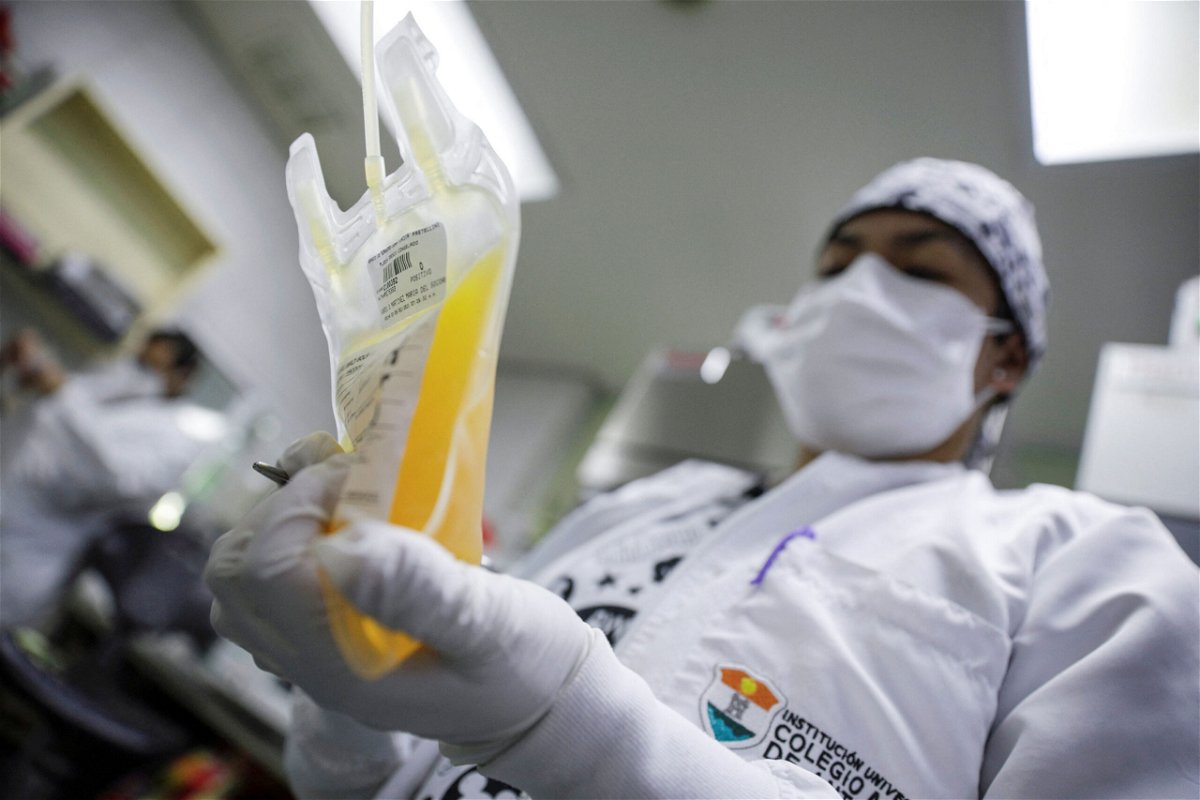 <i>Luis Cortes/Reuters</i><br/>A laboratory technician holds a bag of convalescent plasma