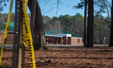 Police tape hangs from a sign post outside Richneck Elementary School following a shooting in Newport News
