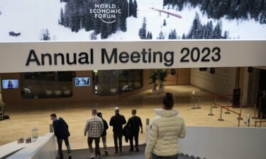 People step down the stairs inside the Davos Congress Center at the eve of the annual meeting of the World Economic Forum in Davos