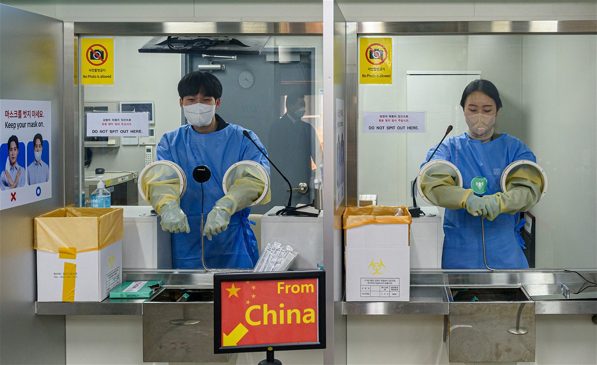 <i>Kim Jae-Hwan/SOPA Images/LightRocket/Getty Images</i><br/>South Korean quarantine officials seen preparing PCR tests for travelers arriving from China at the Incheon International Airport near Seoul.
