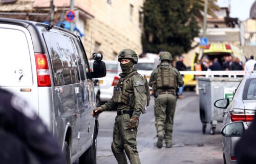 Israeli security personnel work near the scene of Saturday's shooting.