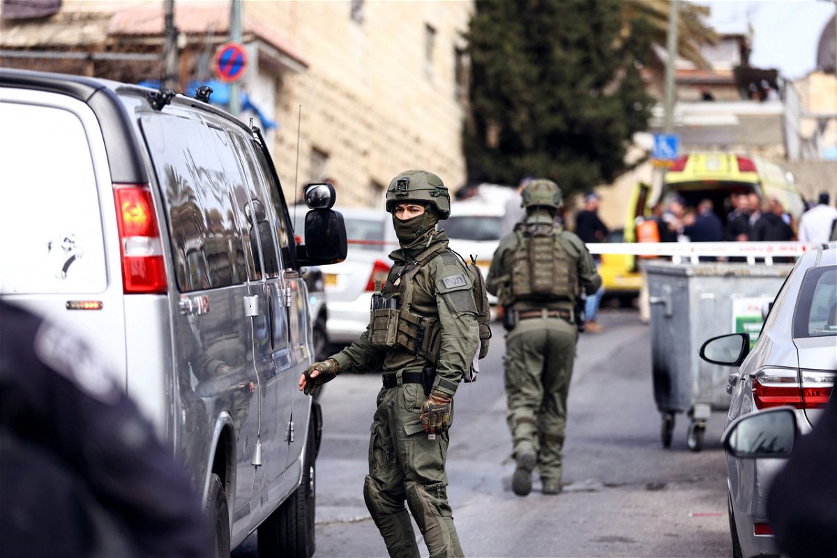 <i>Ronen Zvulun/Reuters</i><br/>Israeli security personnel work near the scene of Saturday's shooting.