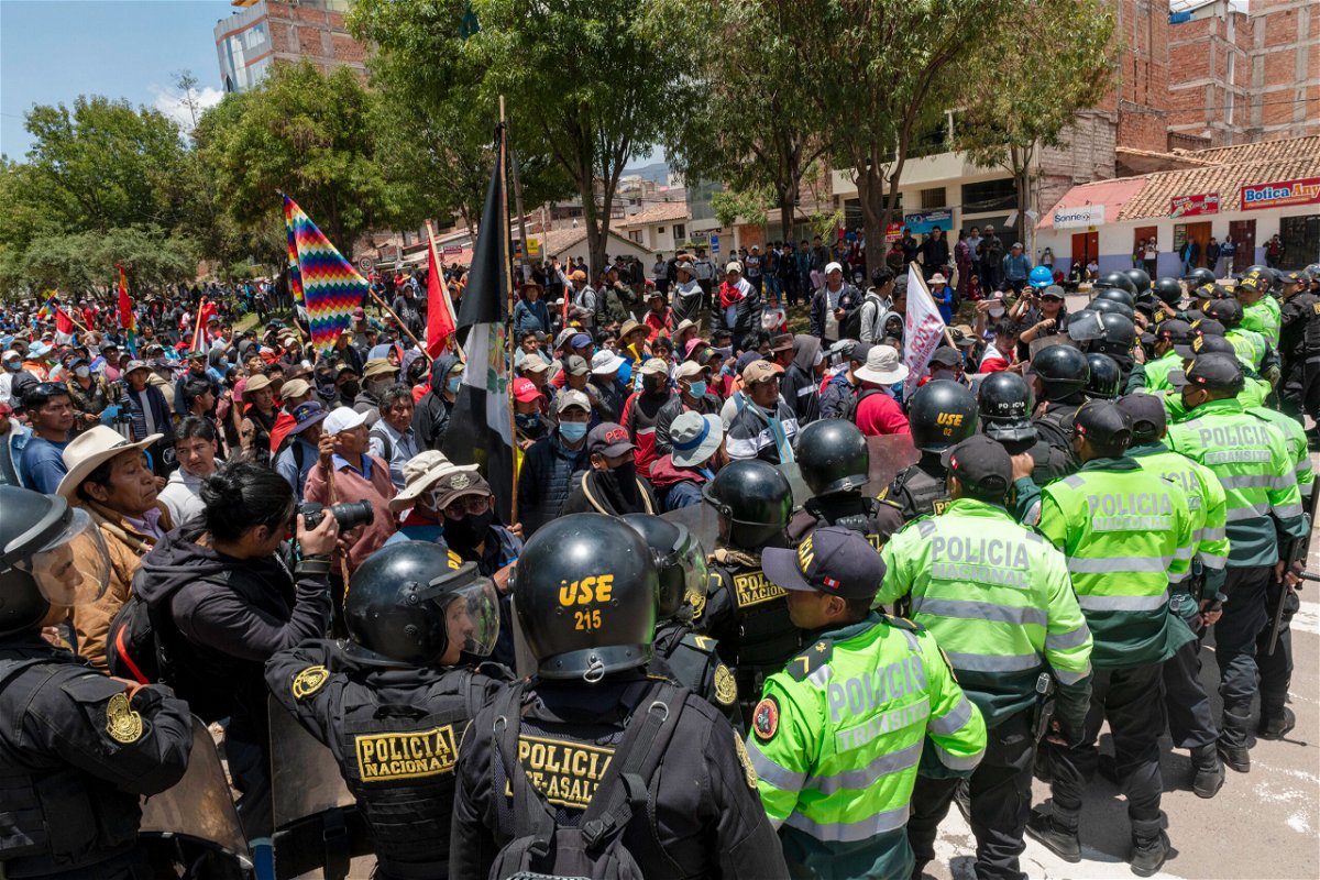<i>Michael Bednar/Getty Images</i><br/>Demonstrators confront police forces as they block the way to Alejandro Velasco Astete International Airport.