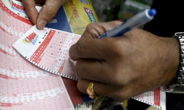 A man fills out a Mega Millions form playing for the Mega Million jackpot estimated at $1.35 Billion