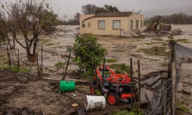 Floodwaters inundate a home by the Salinas River near Chualar