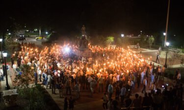 White Supremacists encircle counter protestors at the base of a statue of Thomas Jefferson after marching through the University of Virginia campus with torches in Charlottesville