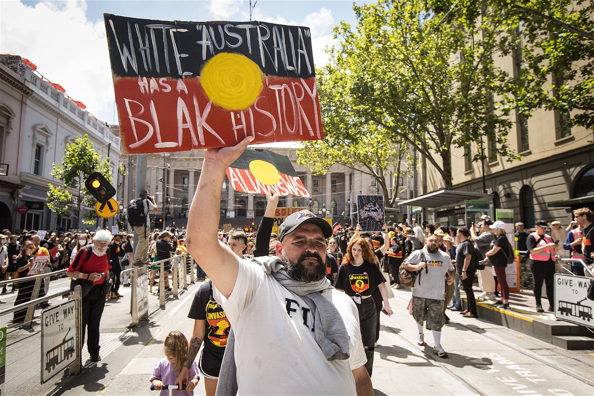 <i>Darrian Traynor/Getty Images</i><br/>People march down Bourke street during the Invasion Day rally on January 26 in Melbourne