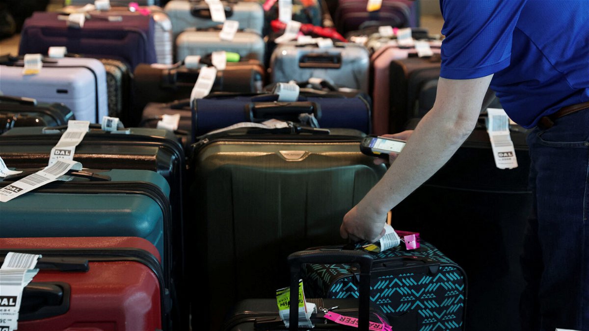 <i>Shelby Tauber/Reuters</i><br/>Southwest Airlines employees assist passengers in locating their luggage after U.S. airlines