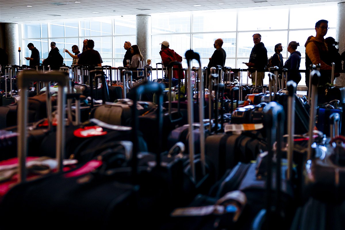 <i>Michael Ciaglo/Getty Images</i><br/>Southwest Airlines travelers wait in line in a baggage holding area at Denver International Airport on December 28
