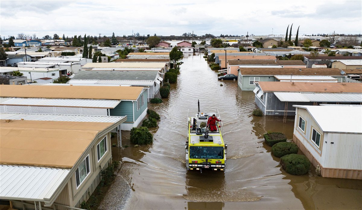 <i>Josh Edelson/AFP/Getty Images</i><br/>This aerial view shows rescue crews assisting stranded residents in a flooded neighborhood in Merced