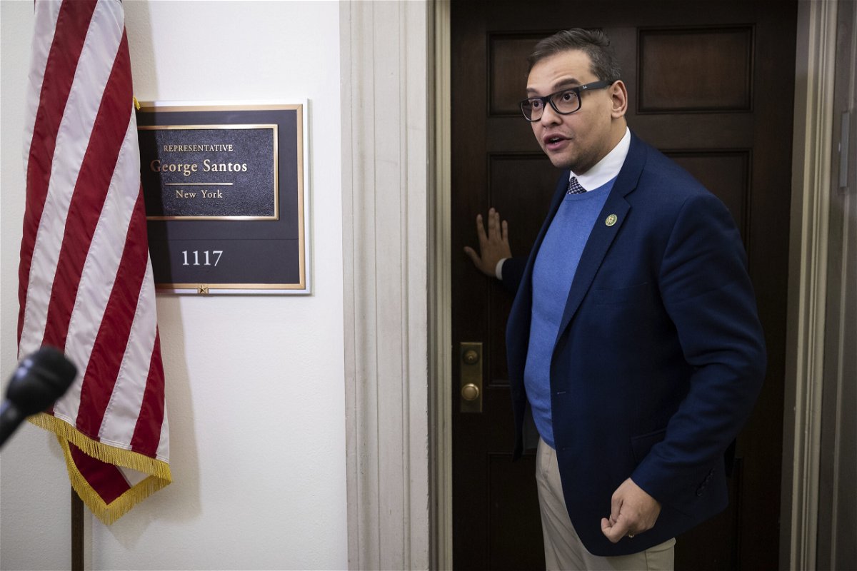 <i>Francis Chung/Politico/AP</i><br/>Rep. George Santos speaks with journalists outside his office on Capitol Hill on January 26.