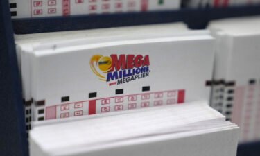 A display holds Mega Million lottery ticket wagering cards at Ted's State Line Mobil station