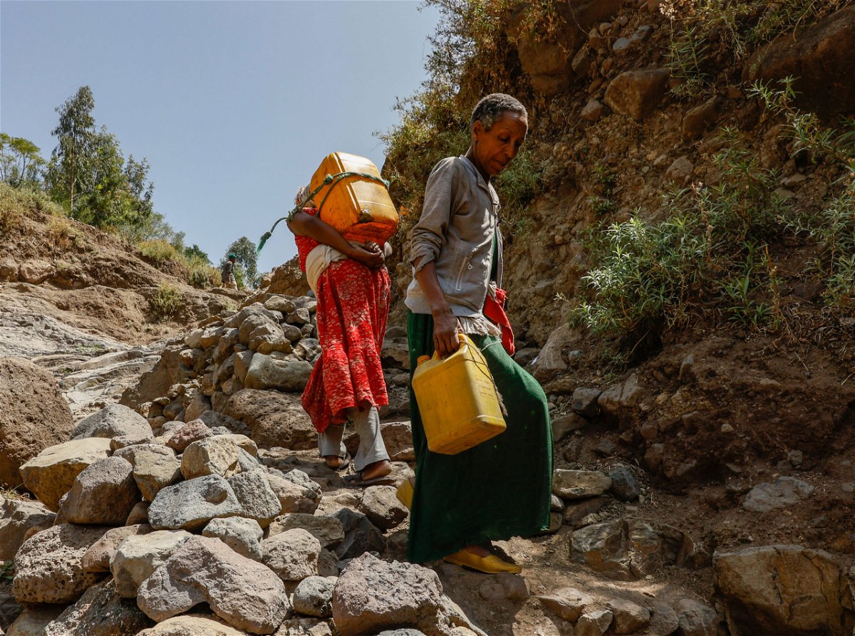 <i>J. Countess/Getty Images</i><br/>A woman in Ethiopia is pictured here carrying water after the armed conflict in the Tigray region knocked out infrastructure.