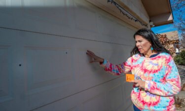 State Sen. Linda Lopez shows bullet holes in her garage door after her home was shot at on January 3 in Albuquerque