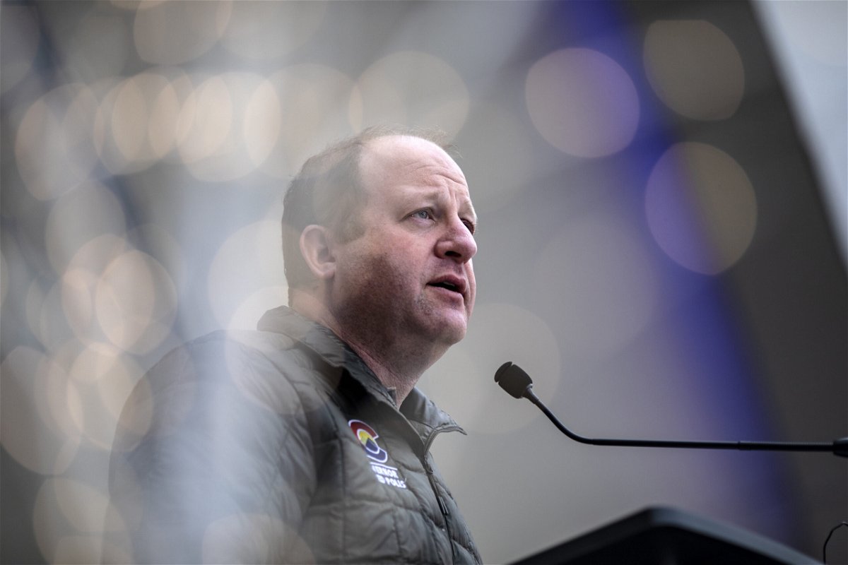 <i>Chet Strange/Getty Images/FILE</i><br/>Gov. Jared Polis had earlier announced Colorado would send migrants out of the state to their intended destinations.