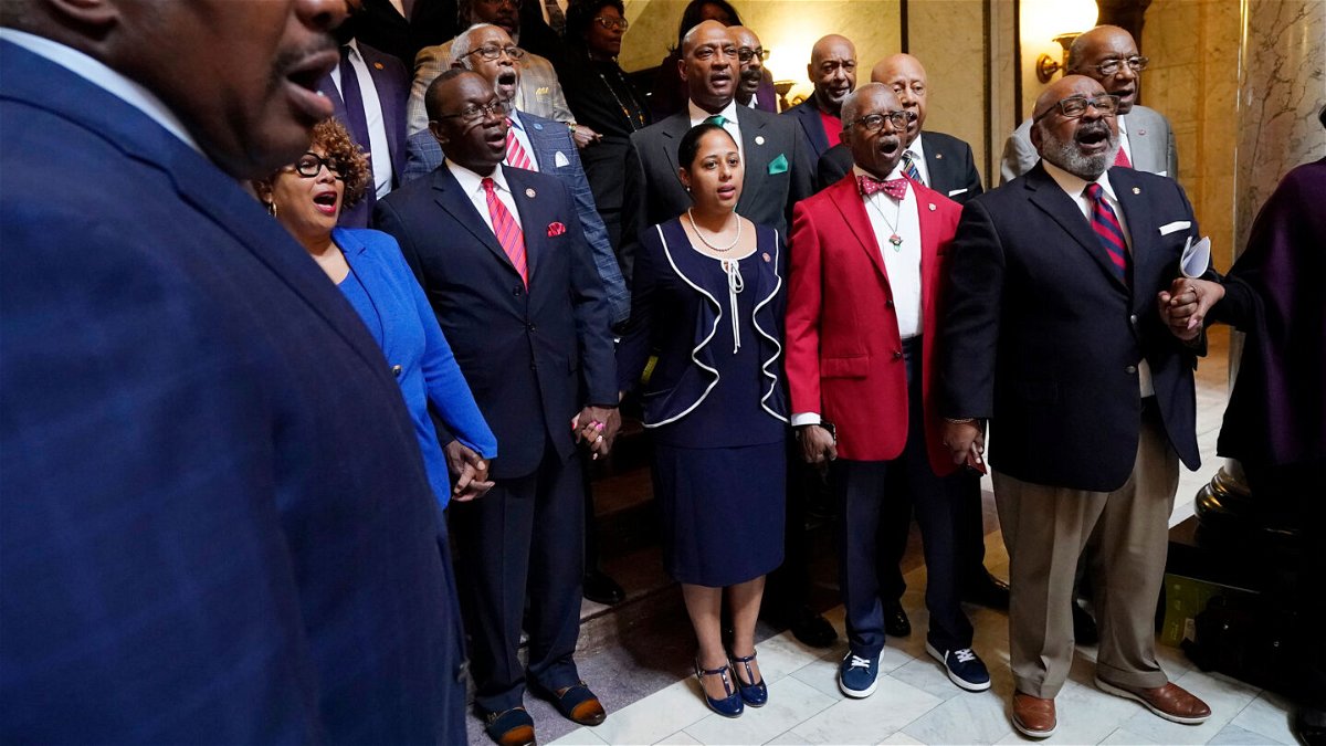 <i>Rogelio V. Solis/AP</i><br/>Members of the Mississippi Legislative Black Caucus hold hands and sing 