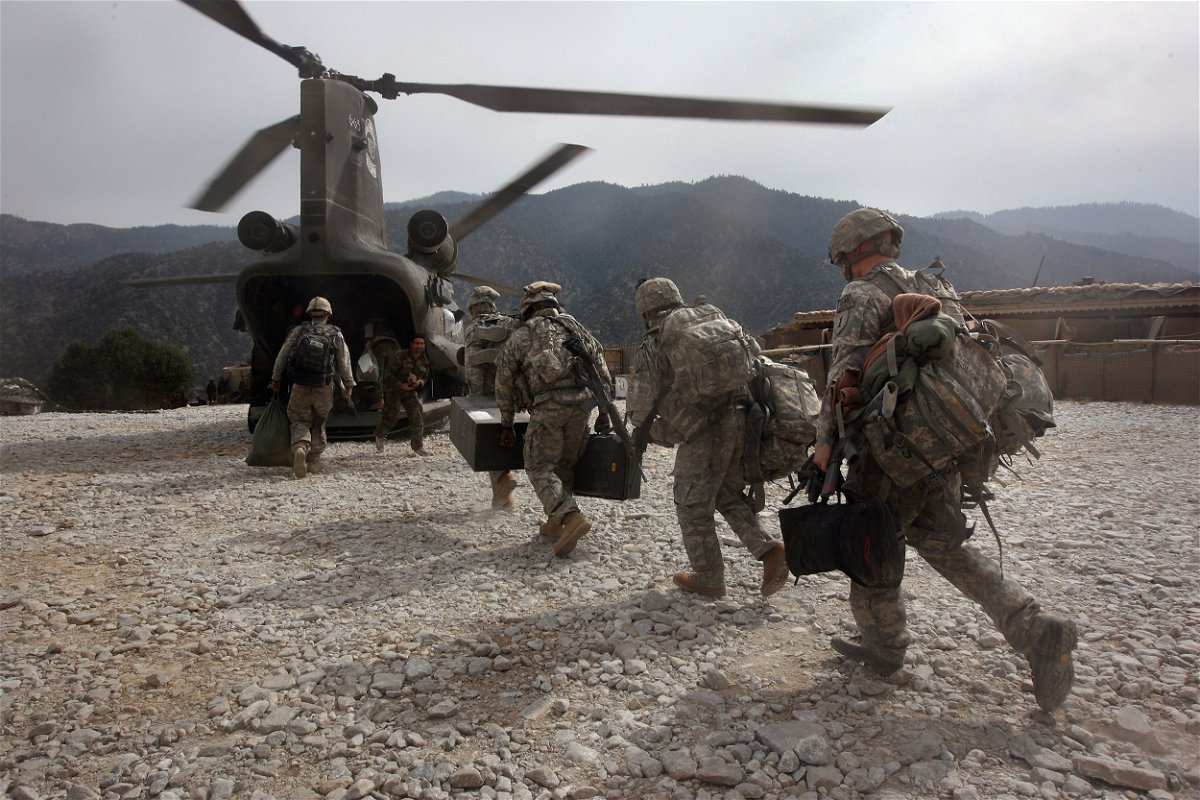 <i>John Moore/Getty Images</i><br/>U.S. soldiers board an Army Chinook transport helicopter after it brought fresh soldiers and supplies to the Korengal Outpost on October 27