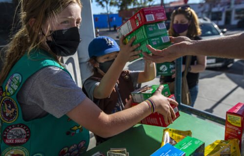 It's Girl Scout cookie season again. Two young girls sell Girl Scout cookies in Los Angeles on February 11