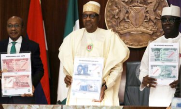 Nigeria reissues the old 200-naira ($0.43) banknotes as cash fiasco threatens to disrupt the general elections later this month. Nigerian President Muhammadu Buhari (C) is pictured here during the launch of the new currency in Abuja