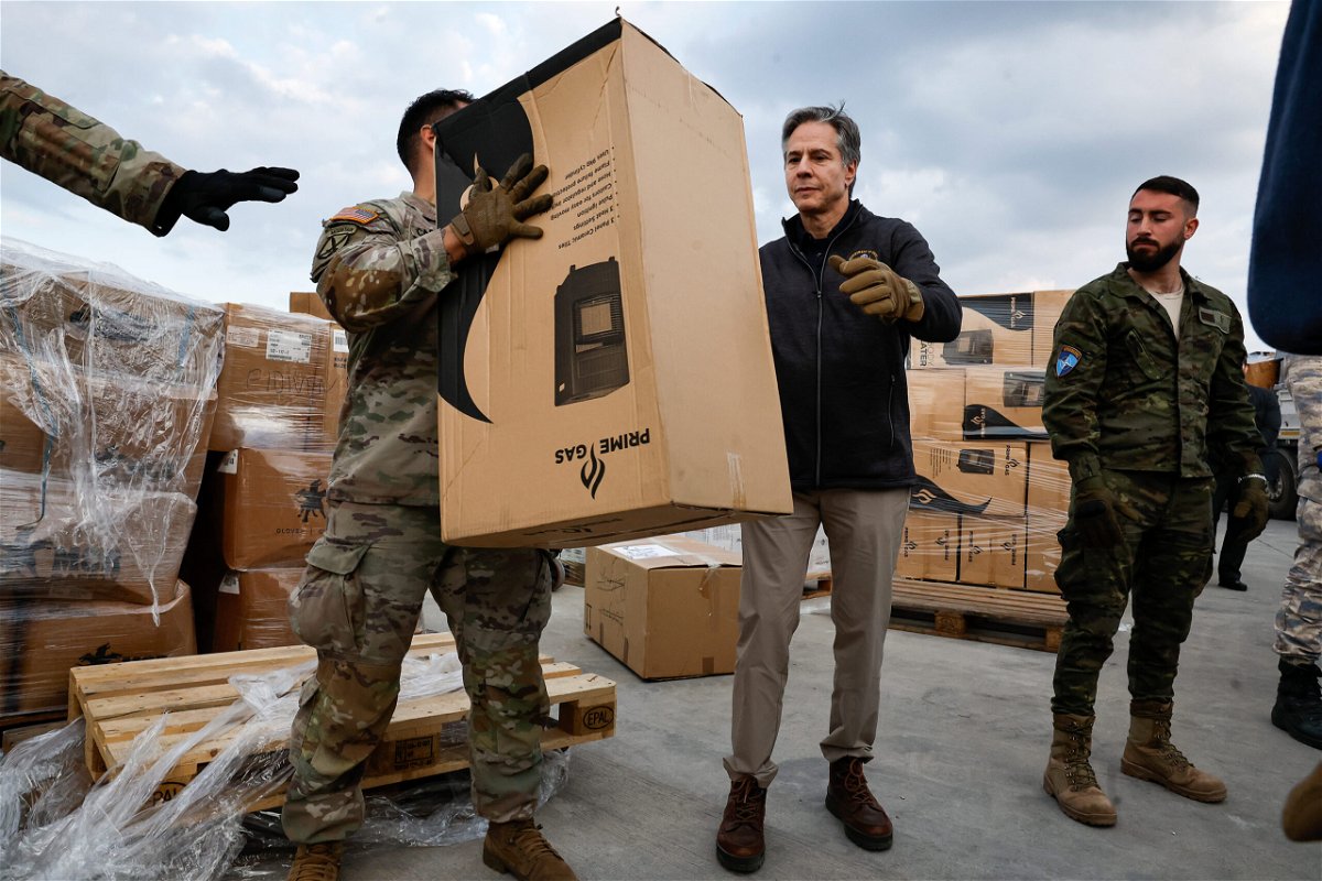 <i>Clodagh Kilcoyne/AP</i><br/>Blinken helps US military personnel load aid onto a vehicle at Incirlik Air Base in Turkey on February 19