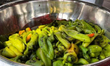 A large bowl of roasted green chile at a market in Hatch