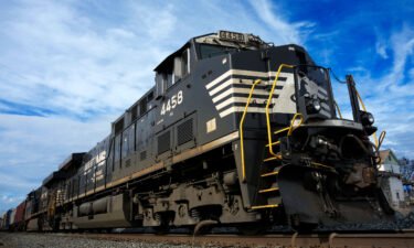 A Norfolk Southern freight train waits to pass through East Palenstine