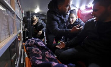 The body of Palestinian Mithkal Suleiman Rayan is transported in an ambulance