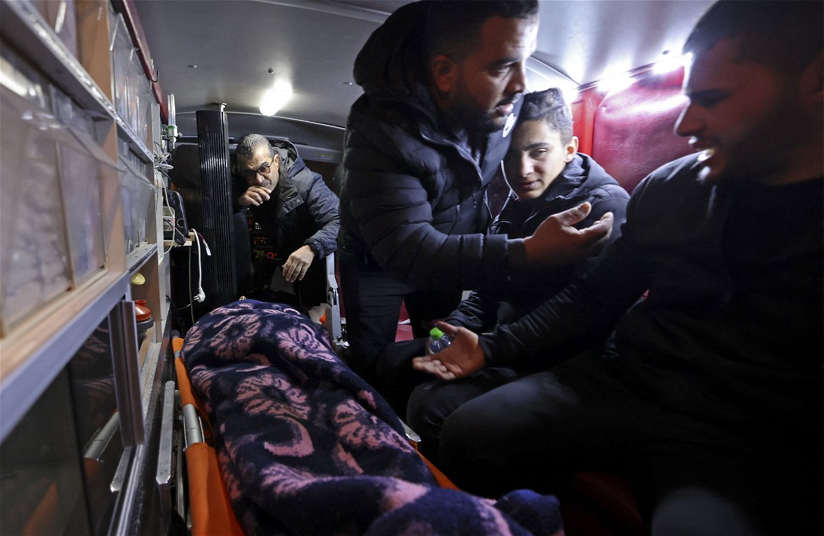 <i>Jaafar Ashtiyeh/AFP/Getty Images</i><br/>The body of Palestinian Mithkal Suleiman Rayan is transported in an ambulance