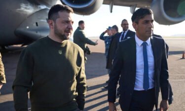 Volodymyr Zelensky walks alongside Rishi Sunak at London's Stansted airport on February 8.