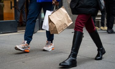 A shopper carries bags in the SoHo neighborhood of New York