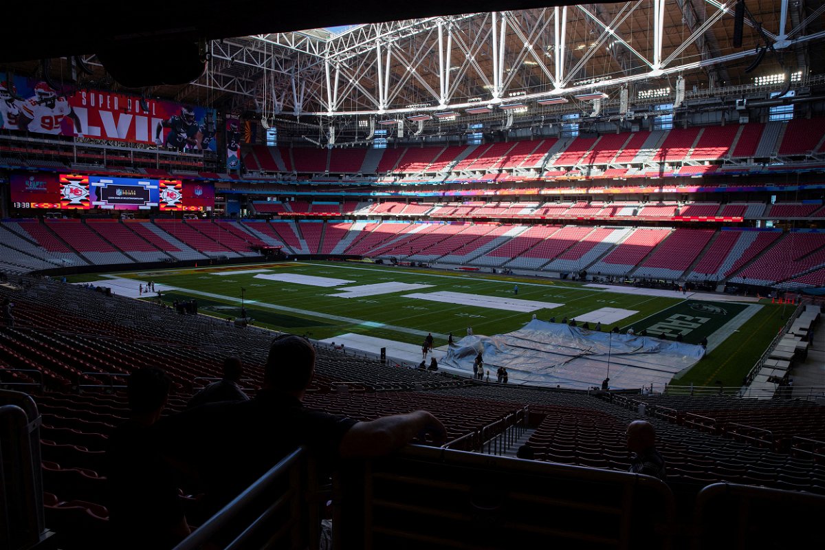 <i>Caitlin O'Hara/Reuters</i><br/>Workers cover the field with a tarp ahead of a rehearsal for the Super Bowl LVII Halftime Show at State Farm Stadium in Glendale