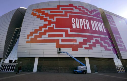 Workers prepare for the NFL Super Bowl LVII football game outside State Farm Stadium on February 1 in Glendale
