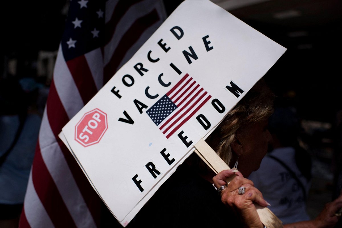<i>Mark Felix/AFP/Getty Images</i><br/>Anti-vaccine rally protesters hold signs outside of Houston Methodist Hospital in Houston