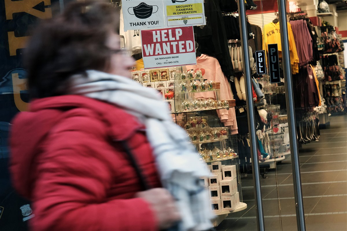 <i>Spencer Platt/Getty Images</i><br/>A woman walks past a 'help wanted' sign displayed in a window of a store in Manhattan on December 02