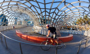 A cyclist rides on the Webb Bridge in Docklands