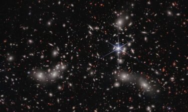 The James Webb Space Telescope just peered into a celestial Pandora's box to see what lies beyond a megacluster of galaxies.