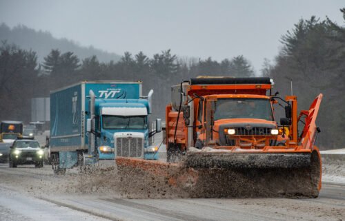 Snow plows trucks clear snow and ice from Interstate highway 93 during a winter storm in Hooksett