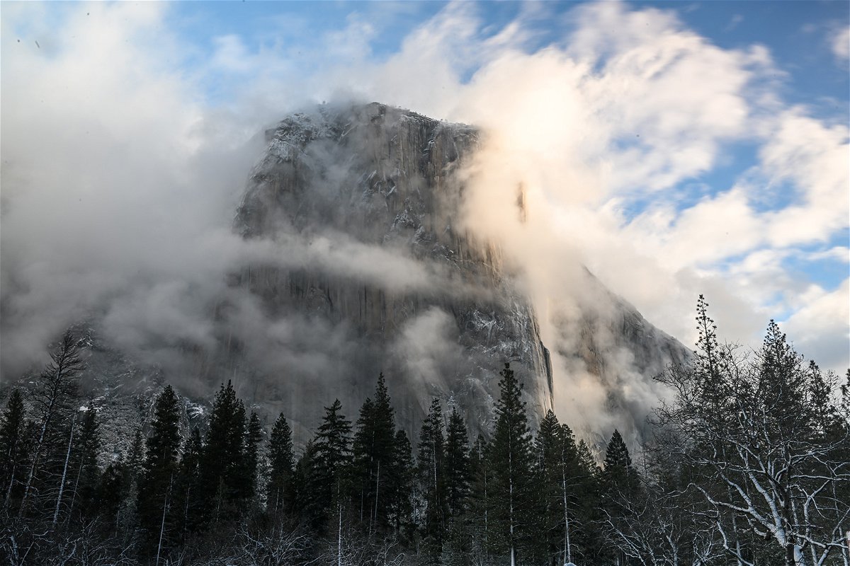 <i>Tayfun Coskun/Anadolu Agency/Getty Images</i><br/>A view of El Capitan as snow blanked Yosemite National Park in California on February 22. The park will partially reopen on March 18.