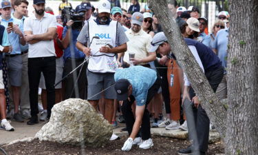 Spieth talks through his next move with a rules official.