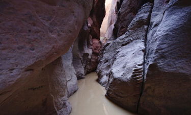 Two men are dead and one is hospitalized after being caught in a flash flood in the 16-mile-long slot canyon known as Buckskin Gulch in southern Utah.