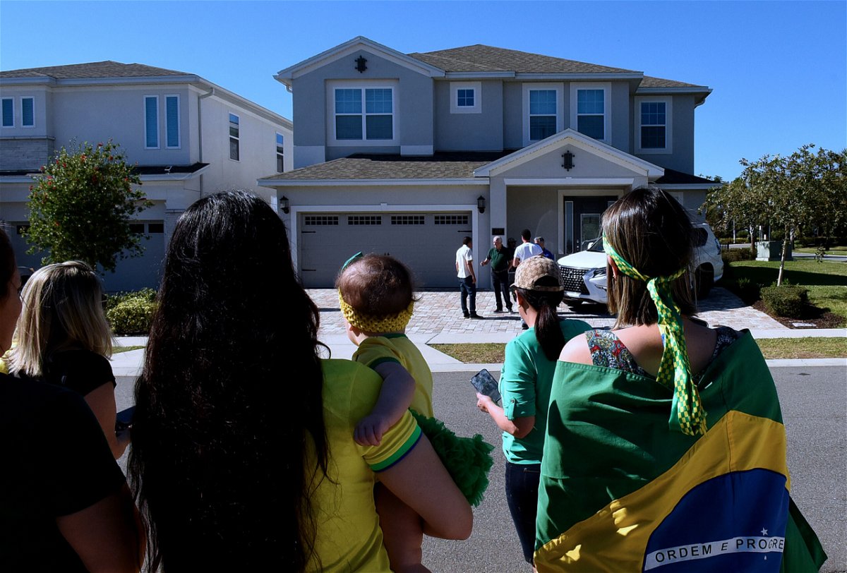 <i>Paul Hennessy/Anadolu Agency/Getty Images</i><br/>Supporters of Bolsonaro stand in front of the home he is staying in