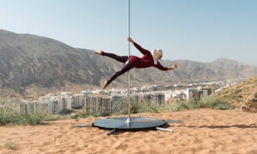 An elegant portrait of a pole dancer in Oman celebrates a woman's strength in nature.