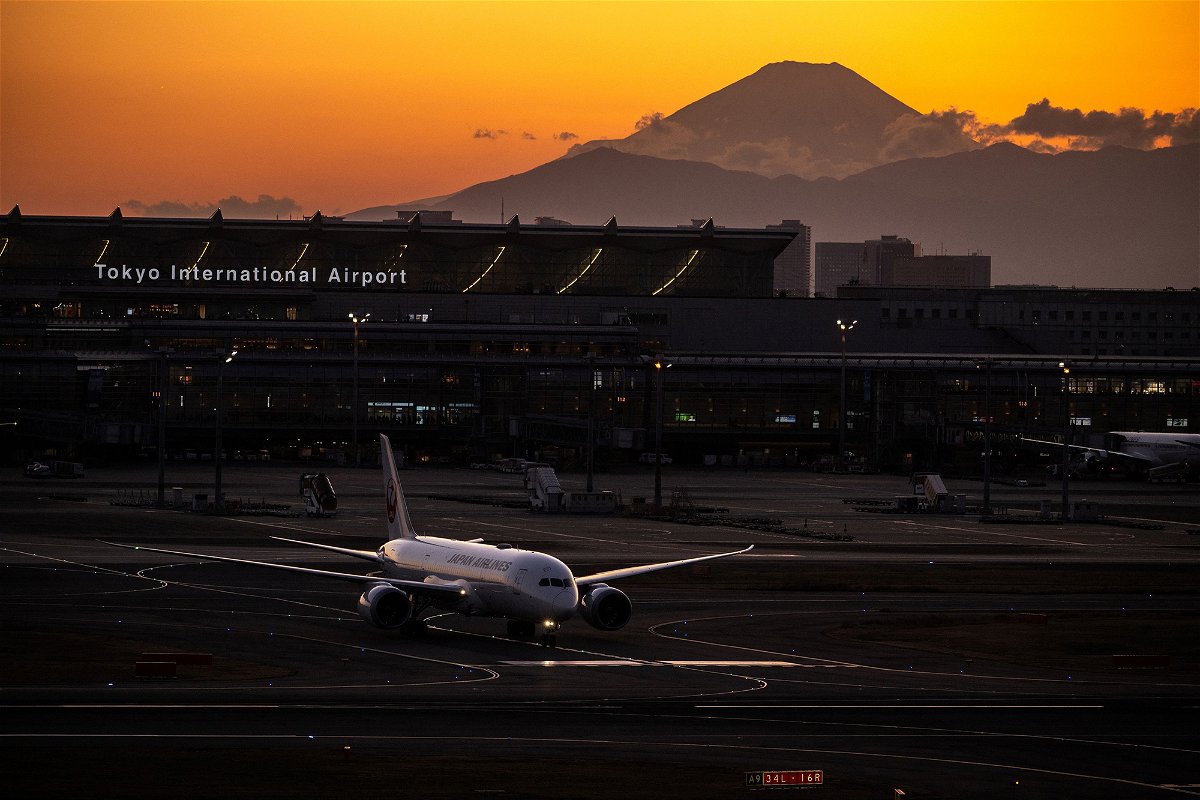 <i>Philip Fong/AFP/Getty Images</i><br/>A Japan Airlines plane is pictured here with Mount Fuji in the background at Haneda Airport in Tokyo in February.