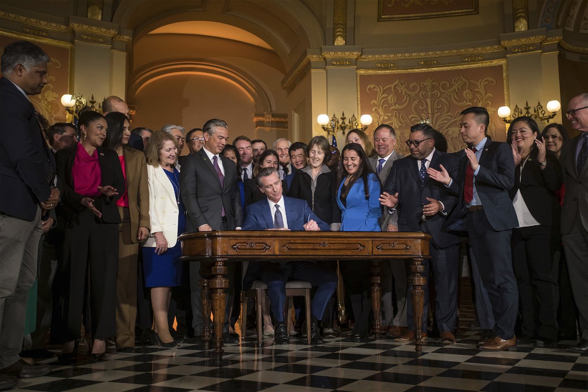 <i>Xavier Mascareñas/The Sacramento Bee/AP</i><br/>Gov. Gavin Newsom signs a bill aimed at addressing gas price gouging while surrounded by legislators and state officials in the Capitol rotunda on March 28 in Sacramento