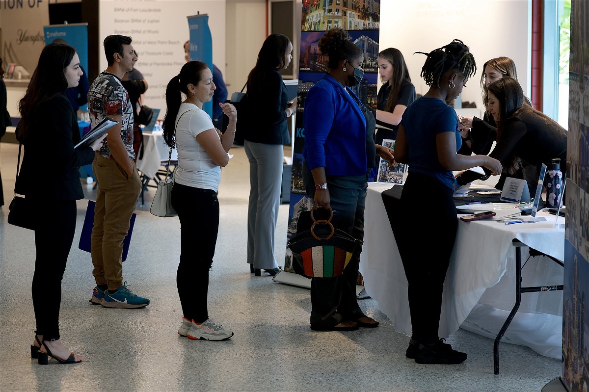 <i>Joe Raedle/Getty Images</i><br/>Job seekers stand in line at the Hyatt booth setup at the Mega South Florida Job Fair held in the FLA Live arena on February 23