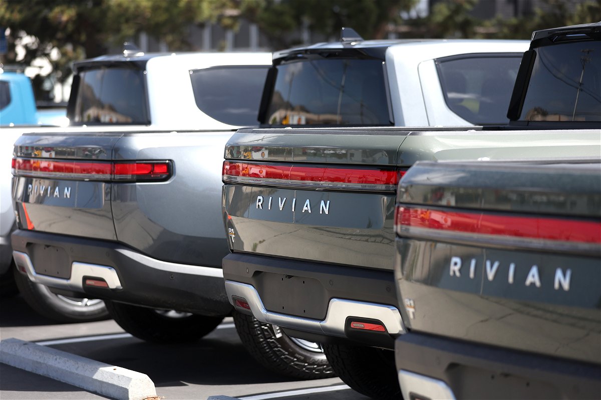 <i>Justin Sullivan/Getty Images</i><br/>Rivian electric pickup trucks sit in a parking lot at a Rivian service center on May 09